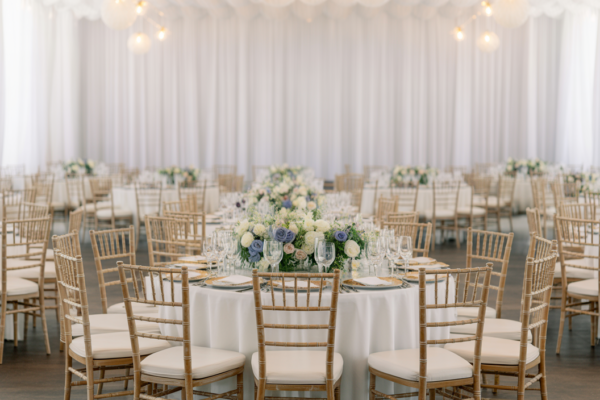 Luxurious wedding reception setup in Virginia with elegant tables and premium chairs on a neutral background
