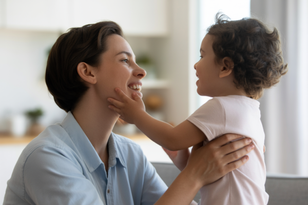 Caring parent engaging positively with child in a bright home environment illustrating ABA therapy parent training