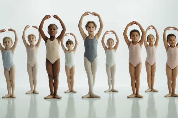 Young ballet dancers practicing in a well-lit professional studio with a clean white background